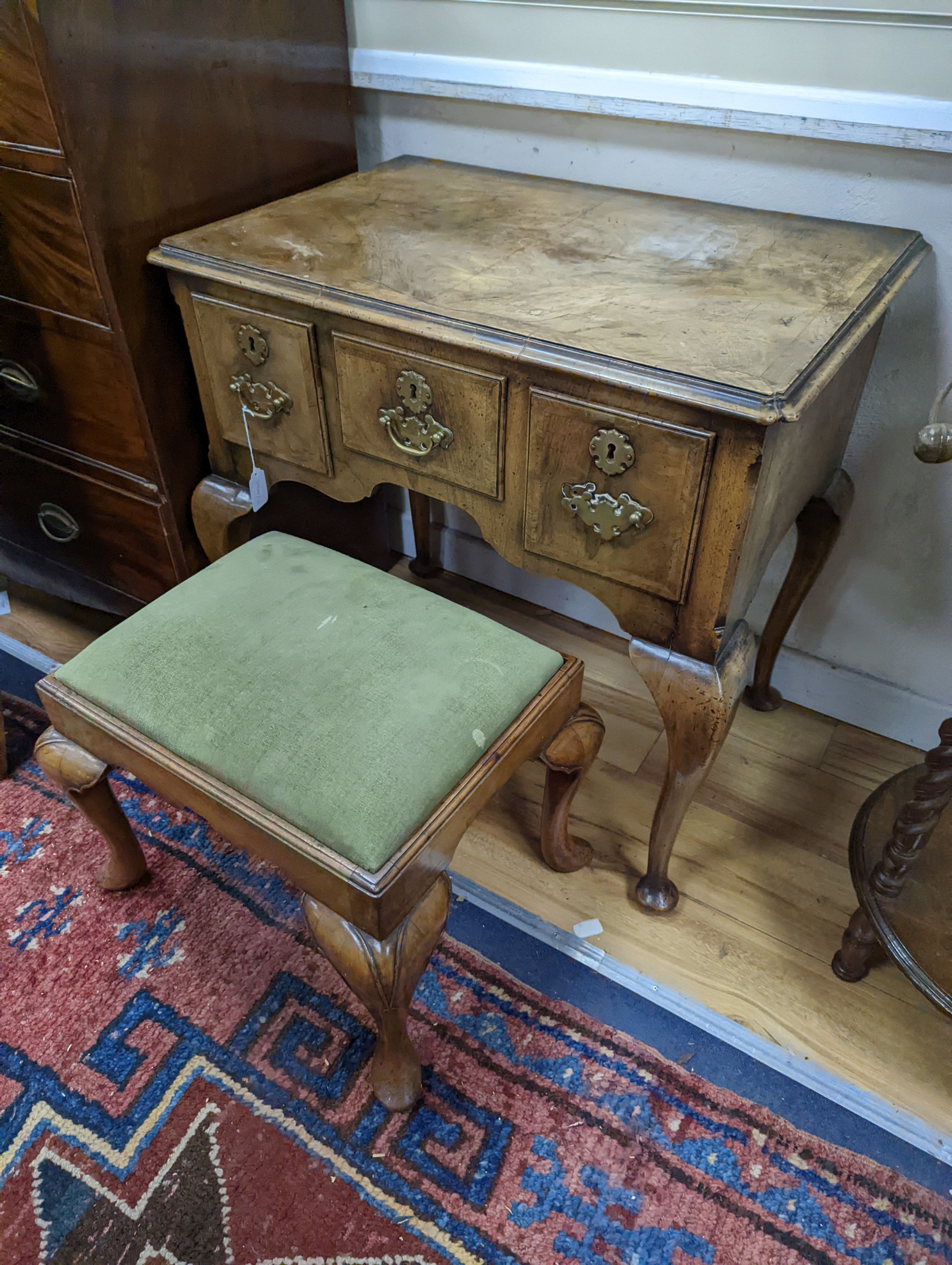 A 1920's Queen Anne revival banded walnut lowboy, width 76cm, depth 51cm, height 75cm together with a similar rectangular walnut dressing stool